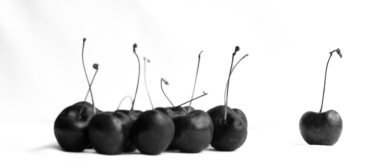 High-key black and white still life of cherries